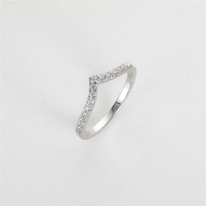 Macro shot of silver S925 V-shaped ring with small shimmering moissanite diamonds