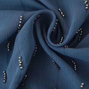 Blue loose camisole with silver beaded straps showing fine chiffon texture and detail