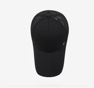 Detail view of the breathable mesh back and silver F-logo on this black outdoor sun cap