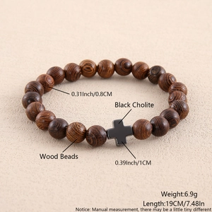 Detail view of 0.8cm wood beads and black hematite cross on this elastic bracelet
