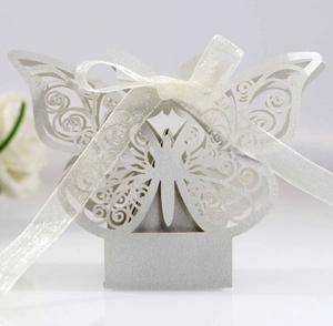 Detailed laser-cut white butterfly candy box with pearlescent finish and ribbon bow
