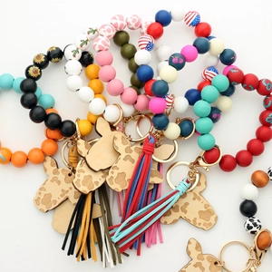 Detail of Western style cow head beaded wristlet keychains with leather tassels