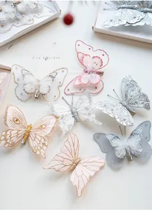 Close-up of mesh butterfly ornaments with feathers, pearls and glitter for Christmas tree
