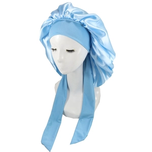 Close-up of light blue satin sleep bonnet with long adjustable ties on a white mannequin