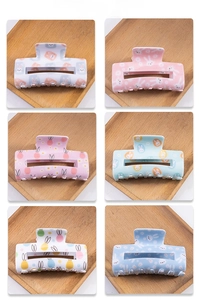 Collection of six cute Easter bunny and floral patterned hair claws on wooden trays