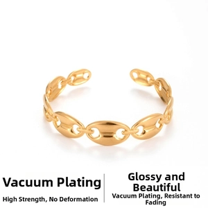 Macro shot of gold leaf-shaped cuff with hammered texture and pig nose buckle detail