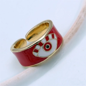 Macro shot of an adjustable red and gold evil eye ring with detailed enamel finish