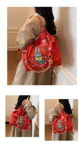 Detailed views of red canvas tote bag with cartoon rabbit embroidery and shoulder straps