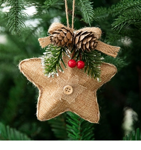 Close-up of burlap star ornament with pine cones and berries on a Christmas tree