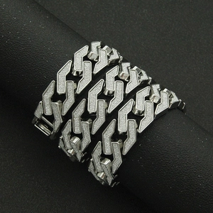Silver cuban link bracelet for men with glitter finish on black display stand