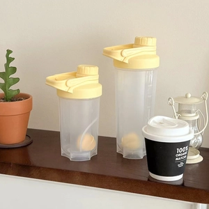 Detailed view of translucent frosted shaker bottles with scale markings and yellow caps