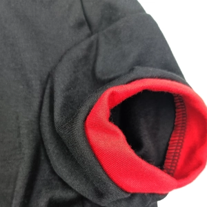 Detailed close-up of double-layered ribbed cuffs on a black and red dog t-shirt