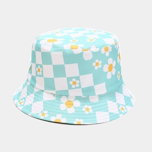 Detail of blue checkerboard sun hat with white daisy prints and fine stitching