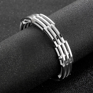 Close-up of triple-row industrial steel cuff bracelet on a professional display