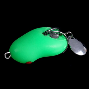 Macro detail of green soft frog lure with rotating metal spinner tail and glossy finish