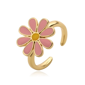 Macro shot of the open pink daisy flower ring with golden finish and enamel detail