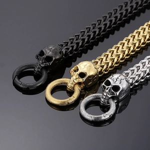 Detail of punk skull bracelet featuring three metal tones and double-row heavy weave chain
