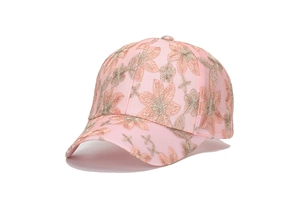 Close-up of pink baseball cap featuring delicate floral embroidery and lace texture