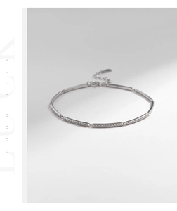 Detailed view of silver bar link bracelet with sparkling pave diamonds and lobster clasp