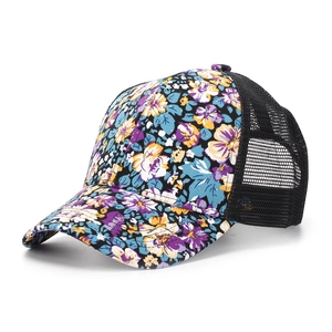 Detail of floral print on baseball cap featuring breathable black mesh and curved brim