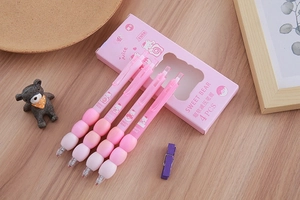 Close-up of pink retractable gel pens with soft grip and cartoon bear packaging box