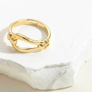 Detailed macro shot of 14K gold plated knot ring featuring an adjustable open band design