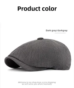 Detail of dark gray herringbone newsboy cap with classic British tweed texture