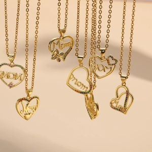 Detail of gold heart pendant necklaces featuring MOM lettering and colorful zircon stones