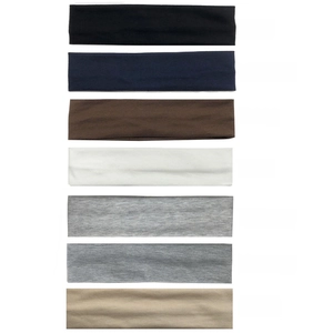 Vertical display showing seven color options for cotton sports sweatbands in a studio shot
