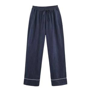 Dark blue denim trousers with elastic drawstring waist and white piping at the leg opening