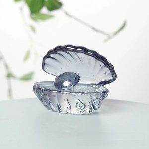 Detailed macro view of a crystal shell figurine with a large faceted blue diamond gem