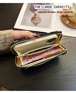 Detail view of large capacity black jacquard long wallet with multi-card slots and phone pocket