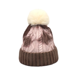 Close-up of cable knit texture and pom-pom detail on tie-dye winter beanie hat