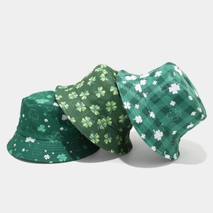 Three green St. Patrick's Day bucket hats with clover patterns in a layered arrangement