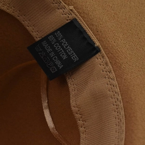 Detail view of the brown wool fedora inner label showing 65% cotton and 35% polyester mix