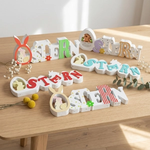 Easter wooden letters OSTERN decor set with bunny and egg designs on wooden surface