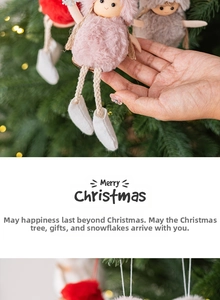 Detail of Christmas plush angel dolls in pink, grey, and red hanging on a tree