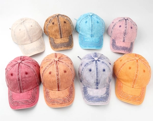 Flat lay of vintage washed cotton baseball caps in eight various colors and finishes