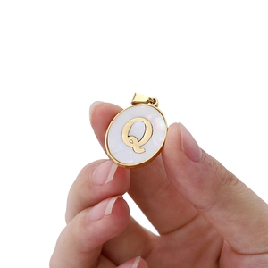 22mm stainless steel oval pendant with white faux shell inlay and golden letter Q