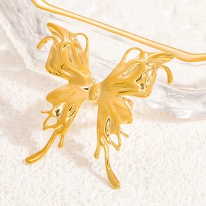 Detailed view of the golden butterfly ring showing hollow wings and polished metal finish