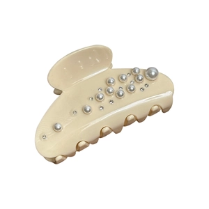 Elegant beige acetate hair claw clip with faux pearls and rhinestones on white backdrop