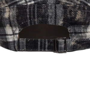 Rear view of vintage plaid newsboy cap with adjustable metal buckle and washed cotton texture