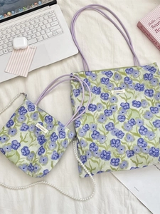 Two-piece floral canvas tote bag set with purple flowers and matching pouch on flat lay