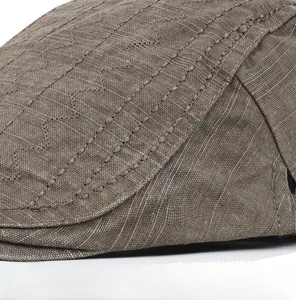 Macro detail of wave embroidery and precise stitching on a cotton flat cap for men