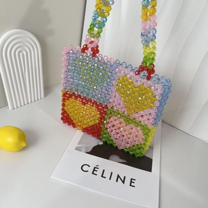 Close-up of handmade multi-color beaded tote bag with bright acrylic geometric patterns