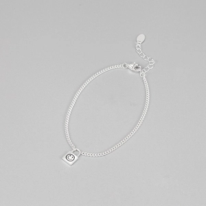 Macro shot of S925 sterling silver chain featuring a smiley face padlock and lobster clasp