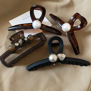 Brown tortoise shell and black acrylic hair claws with elegant pearls and heart gems