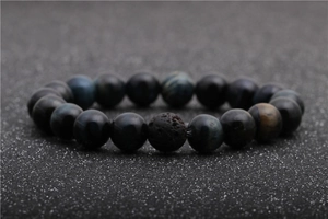 Detailed view of natural tiger eye beads and porous volcanic lava stone on this bracelet