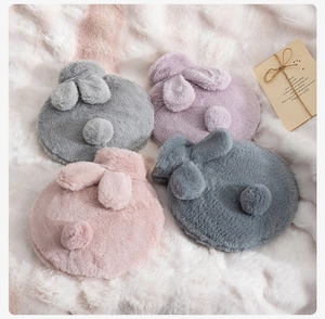 Close-up of fluffy rabbit ear plush covers for hot water bottles in four pastel colors
