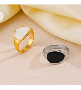 Detailed view of minimalist oval drip oil rings in gold and silver with enamel finish